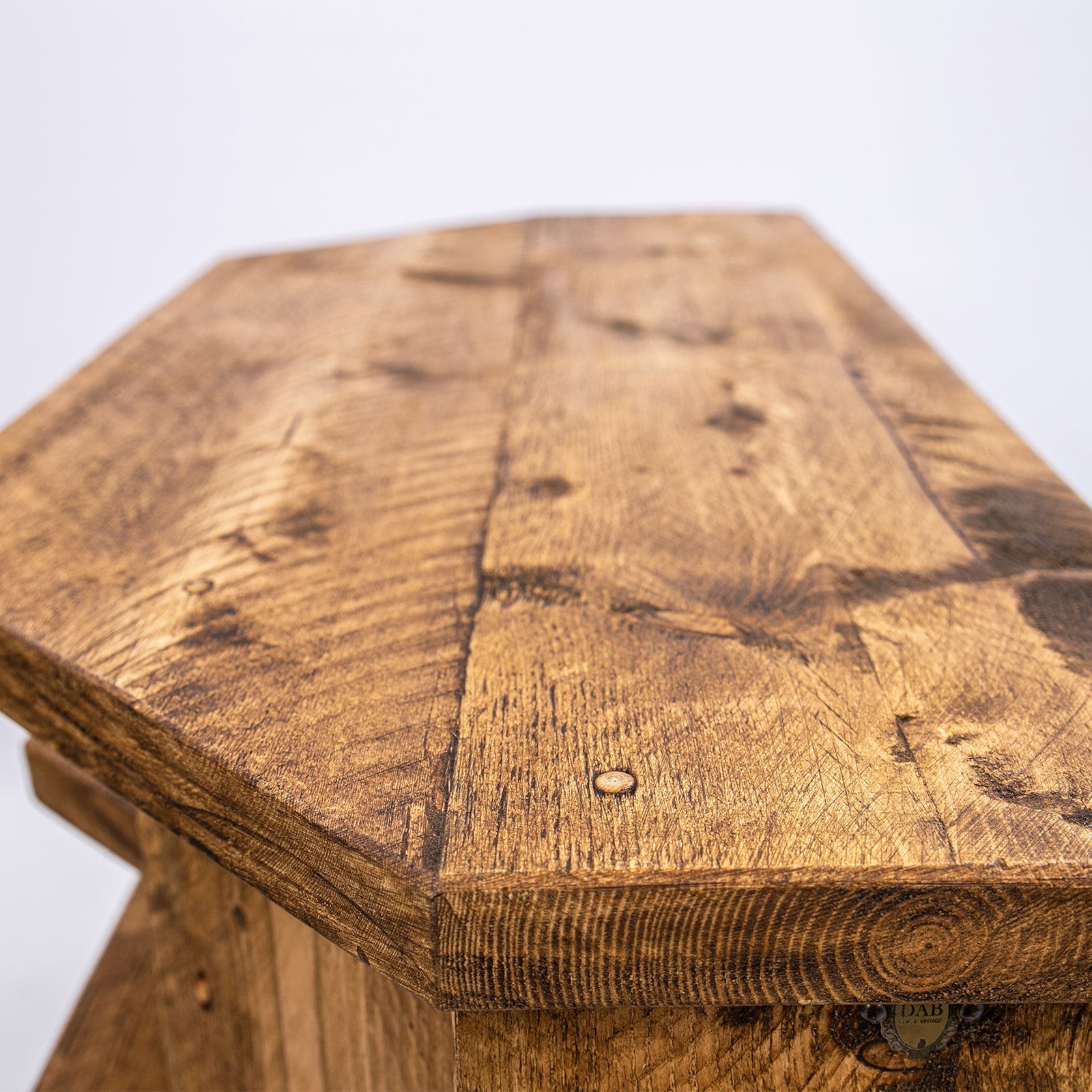 Reclaimed wood hexagonal stool with rustic finish and black steel legs perfect for corner tv units or plant stand