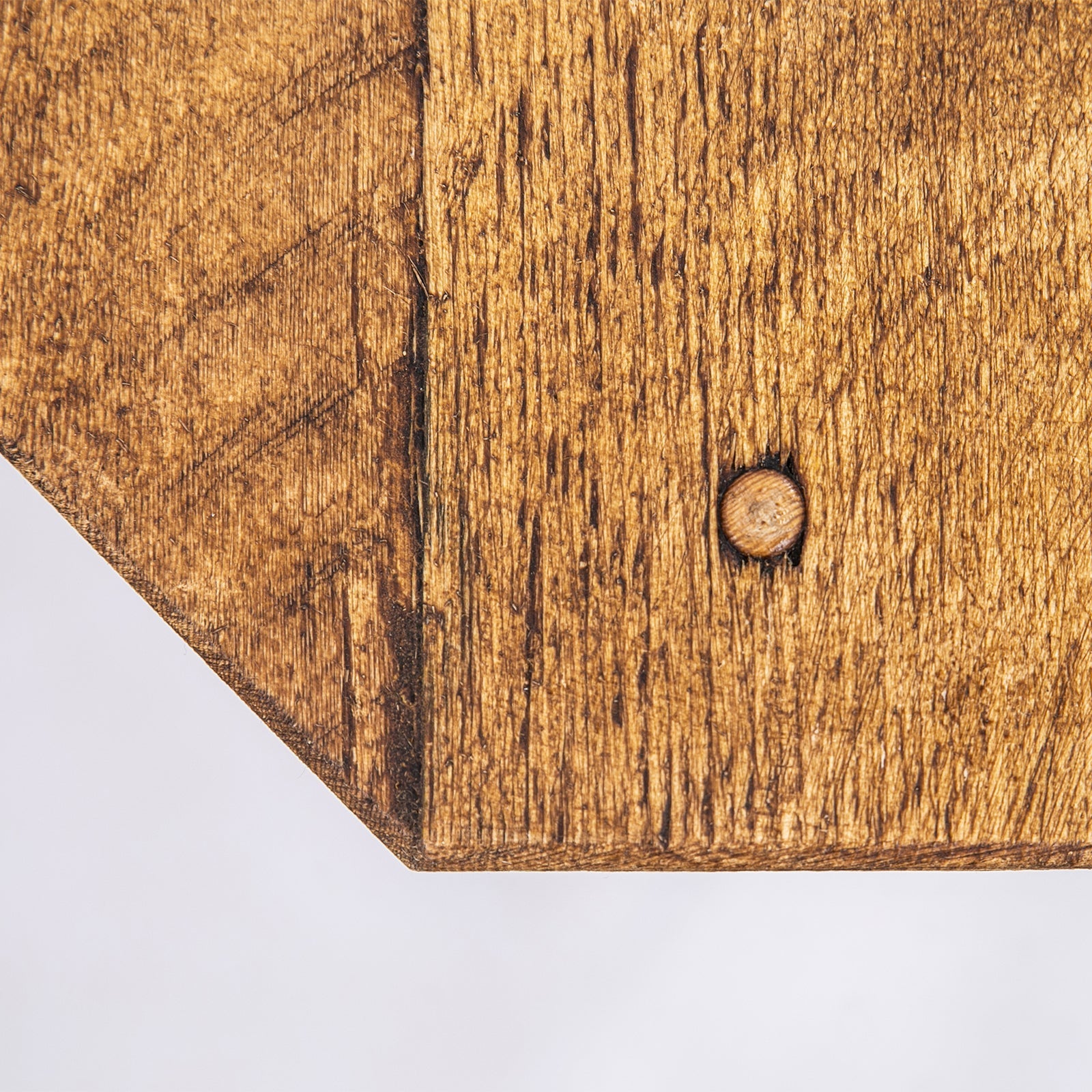 A rustic wooden plant stand with medium brown cutting board top and black steel legs for corner tv units