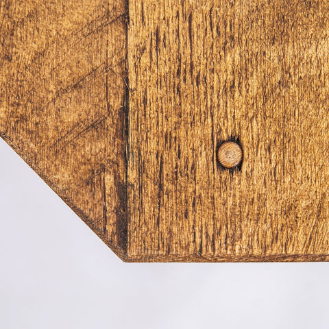 A rustic wooden plant stand with medium brown cutting board top and black steel legs for corner tv units