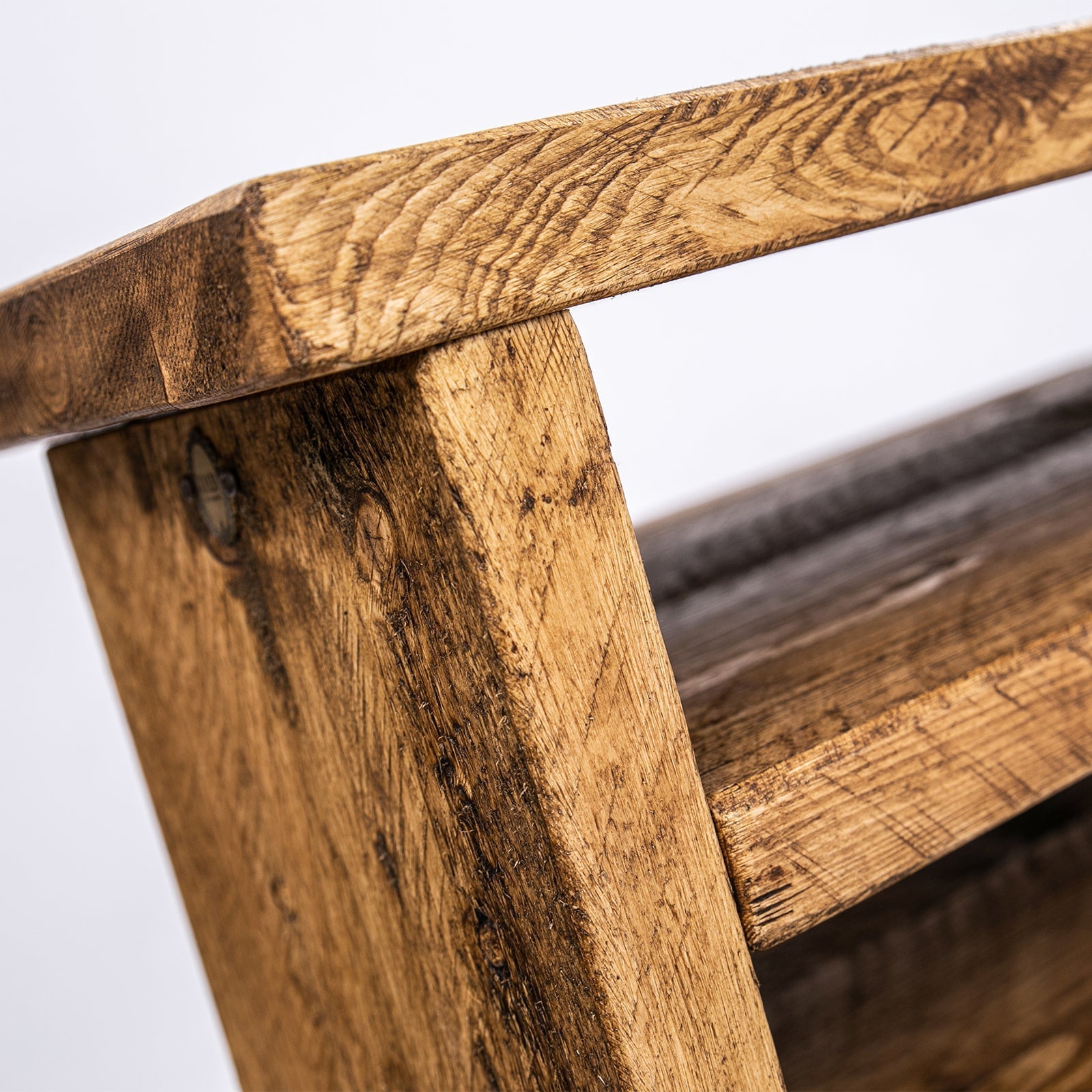 Rustic wooden corner tv unit with visible grain and black steel legs for a sturdy plant stand and media setup