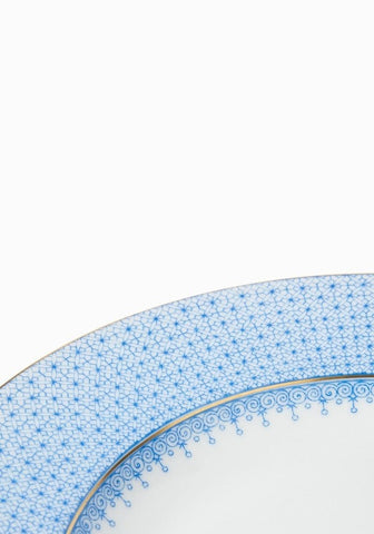 A delicate cornflower blue lace dinner plate set featuring intricate blue and white porcelain with gold trim edges