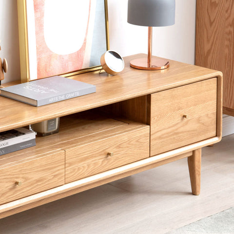 Light oak wood mid-century modern corona tv stand with sleek tapered legs and minimalist drawer pulls