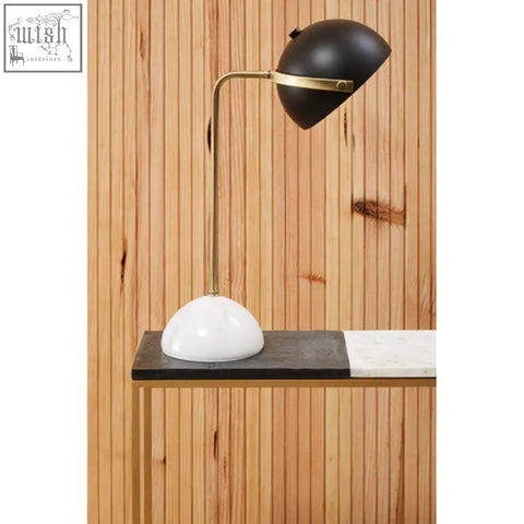 Black and brass desk lamp with white marble base on corra marble console table for stylish lighting and decor