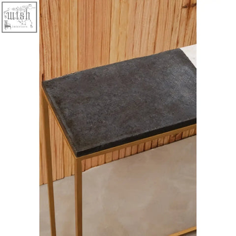 Dark gray stone top marble console table with slender gold metal legs from corra marble console collection