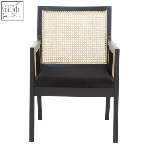 Black corso rattan chair with woven cane back and seat cushion and a sleek black frame