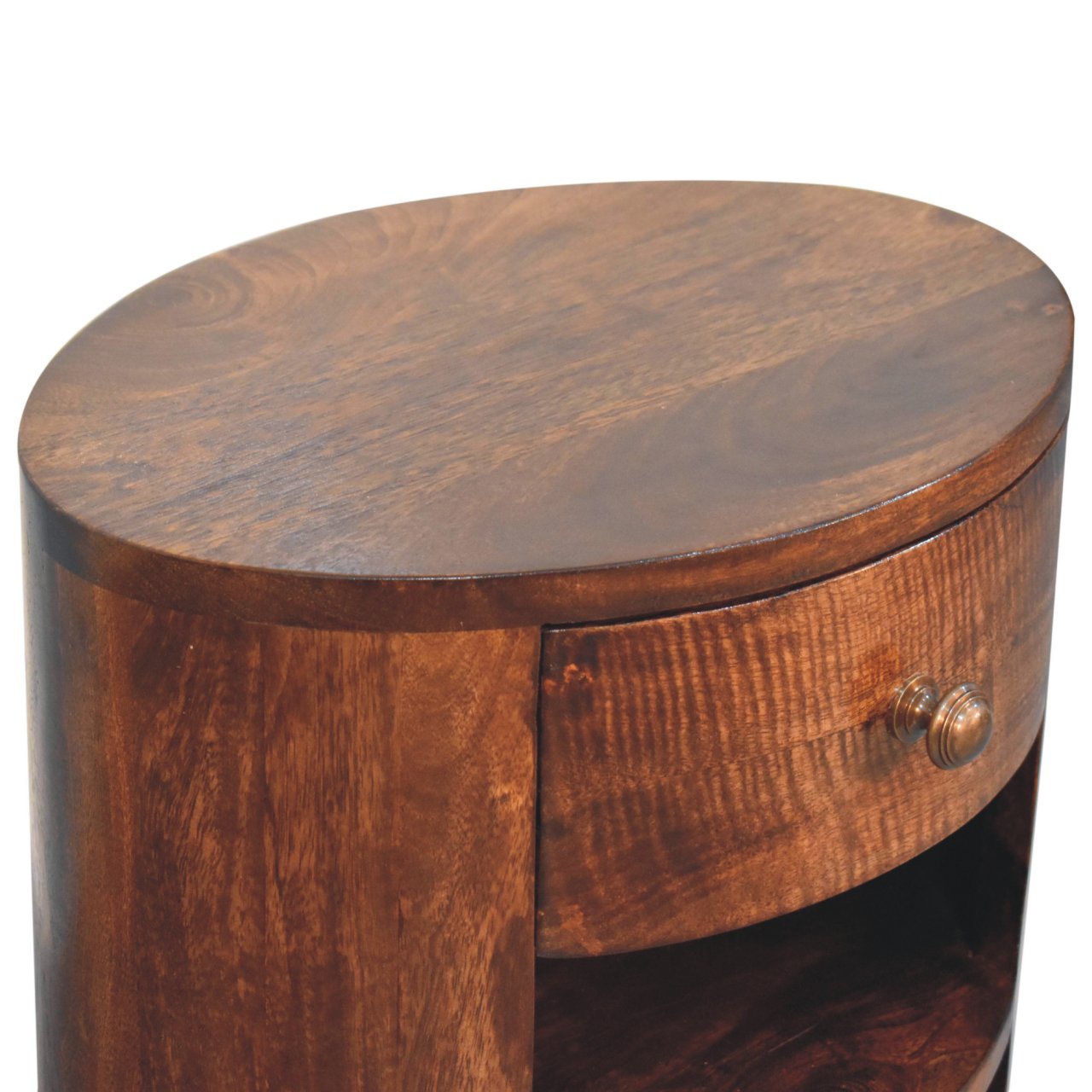 A rich dark brown california walnut nightstand with a smooth oval top and single drawer with a brass knob