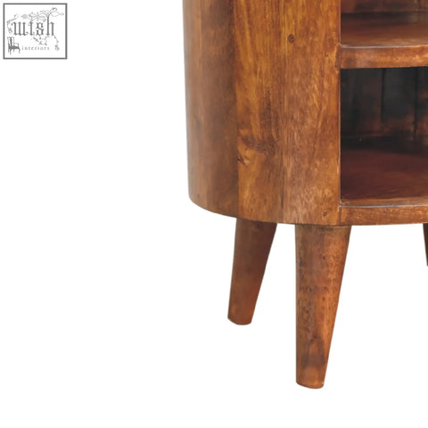 A rustic medium brown cortez chestnut bedside table made of solid mango wood with cylindrical body and tapered legs