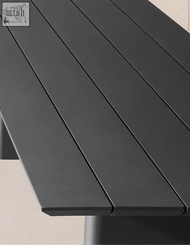 Black matte slatted tabletop of cortez outdoor dining table set with modern design for outdoor dining use