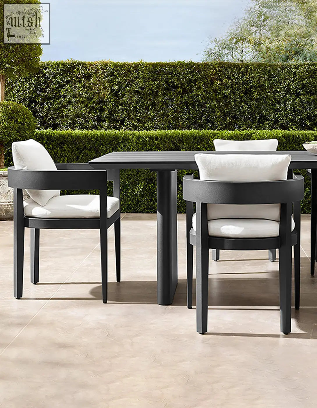 Modern black cortez outdoor dining table set with sleek minimalist design and white cushioned seating for outdoor dining