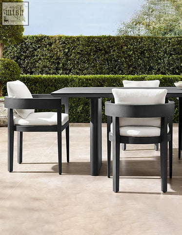 Modern black cortez outdoor dining table set with sleek minimalist design and white cushioned seating for outdoor dining