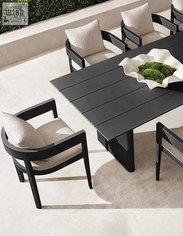 Modern black cortez outdoor dining table set with sleek minimalist design and beige cushioned chairs for outdoor dining