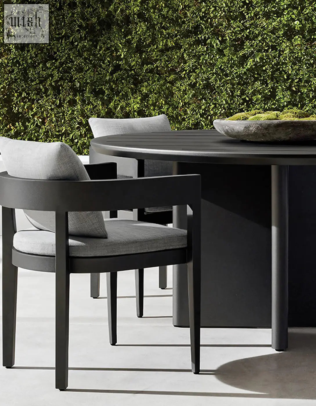 Modern black cortez outdoor dining table set with sleek round table and gray upholstered cushioned chairs for outdoor dining
