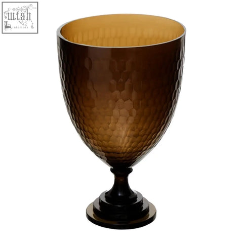 Amber-colored cortina large honeycomb glass candle holder with hammered texture and dark base and stem