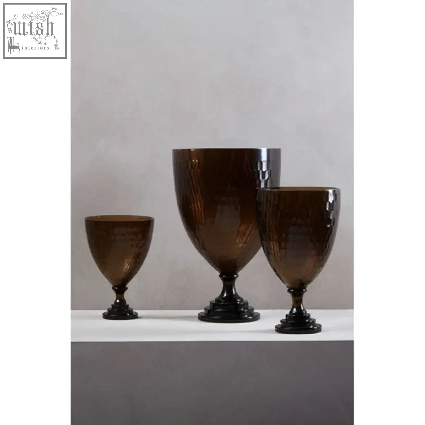 Set of three amber cortina large honeycomb glass candle holders with a textured hammered finish and dark bases