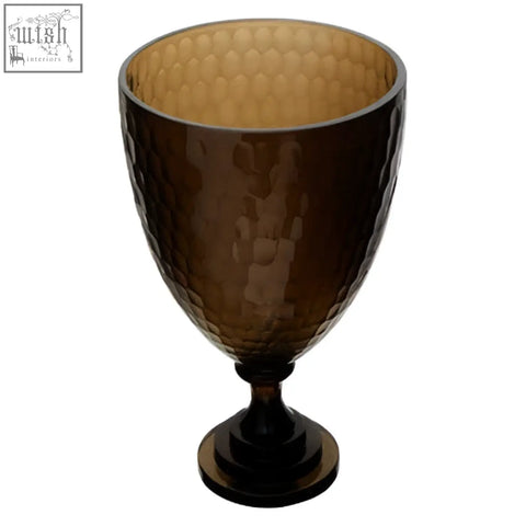 Brown hammered glass candle holder with honeycomb textured interior and sleek pedestal base for stylish glass candle use