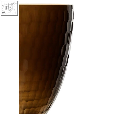 Amber-colored hammered glass candle holder with textured hexagonal honeycomb pattern for candles
