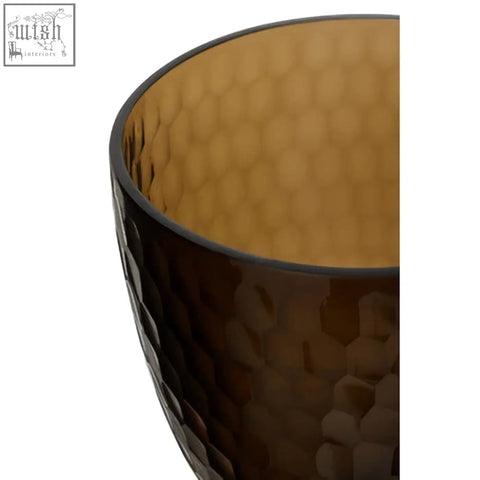 Amber-colored cortina medium honeycomb glass candle holder with textured exterior and smooth interior glass candle holder