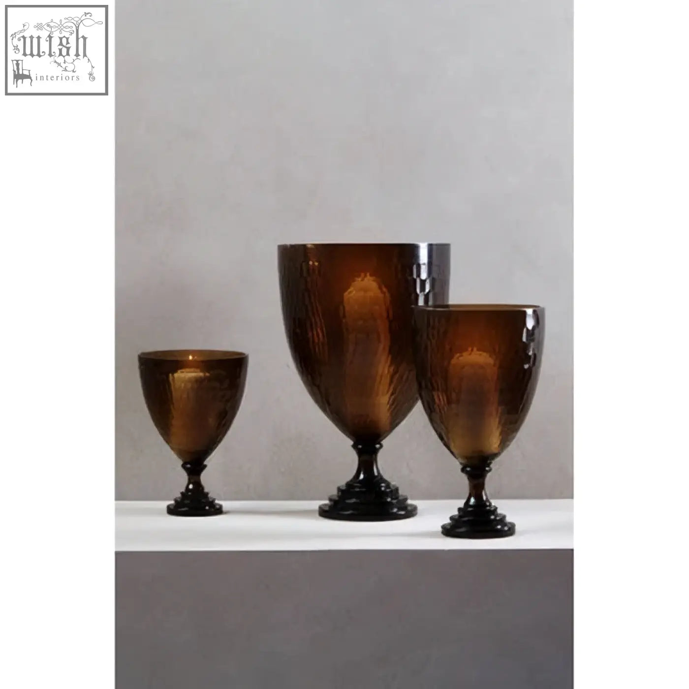 Set of three amber glass candle holders with black bases and gold leaf etching perfect as glass candle holders