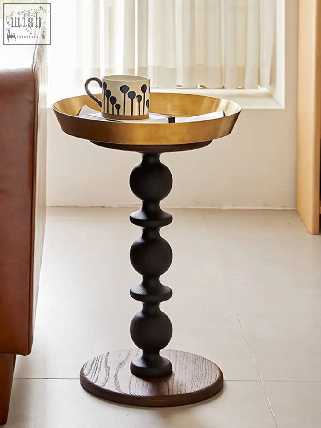 Cosmo round side table with a gold tray featuring a black ball-and-socket pedestal and dark wood foot for a delightful blend
