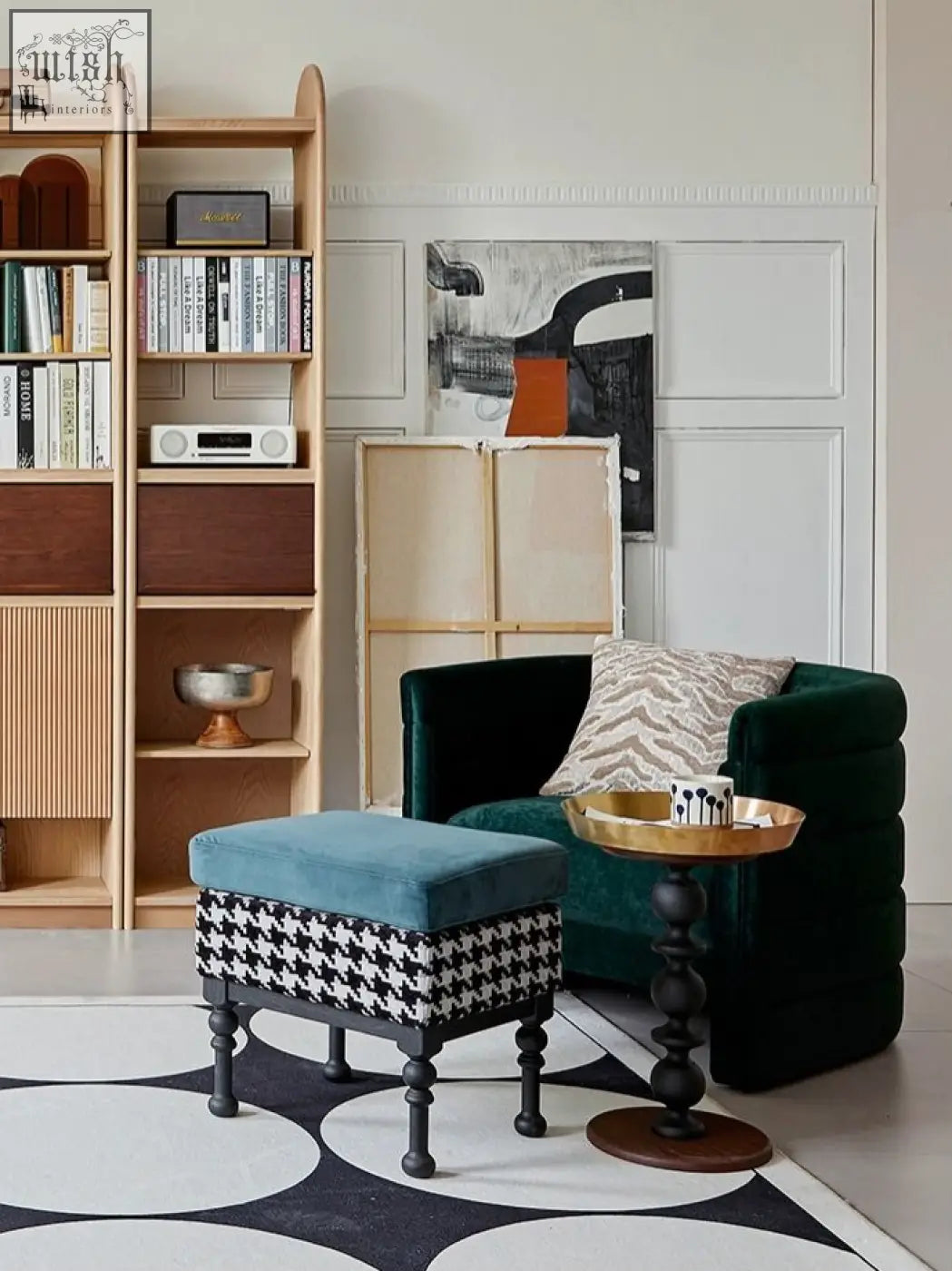 A cosmo round side table with a plush teal velvet ottoman and black and white houndstooth base with gold tray