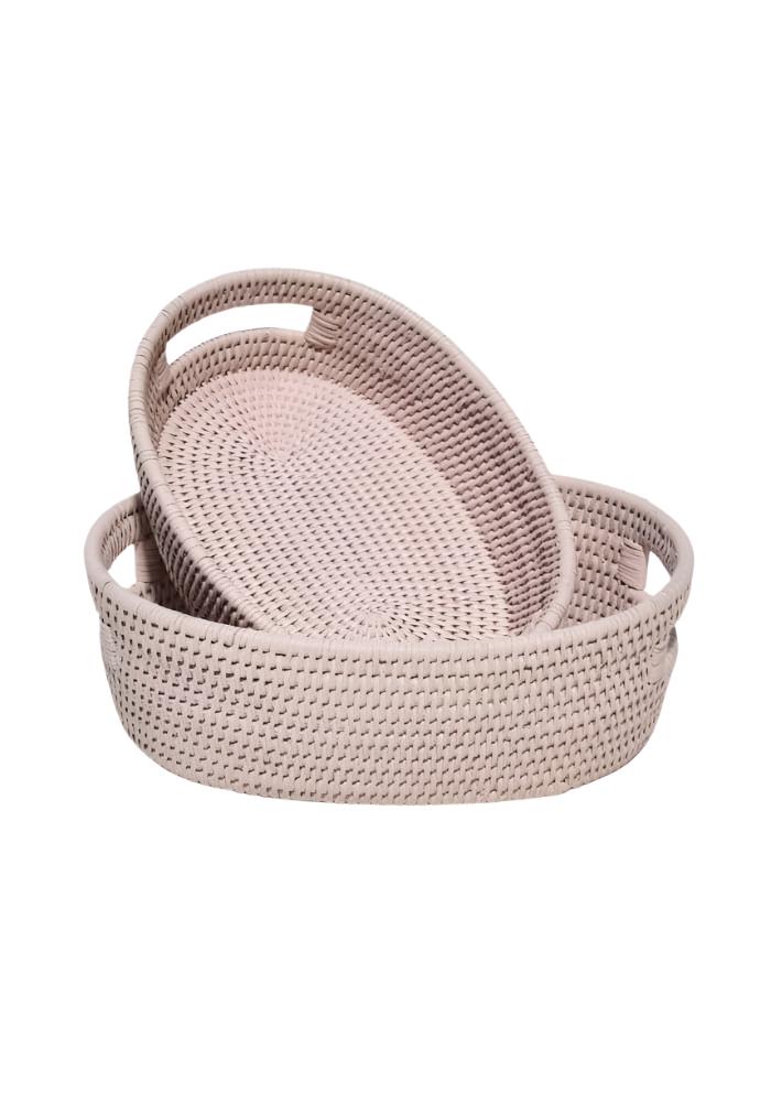 Beige woven rattan oval trays with integrated handles in the cotswolds oval rattan basket pink set of 2
