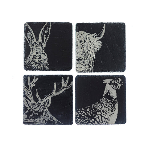 Set of four black slate coasters with white engraved country animals including hare, stag, highland cow, and pheasant