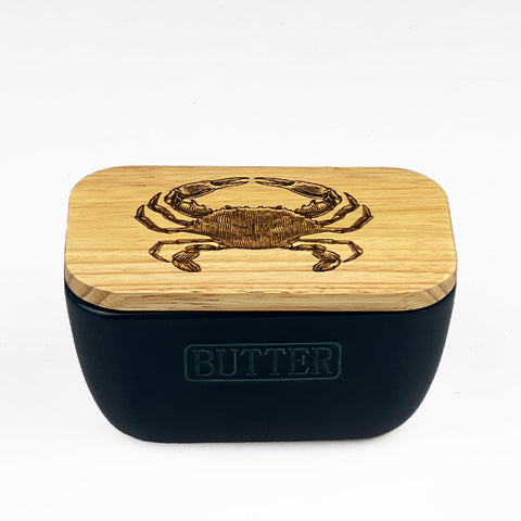 Navy blue ceramic butter dish with light wood lid engraved crab design and butter embossed on the front