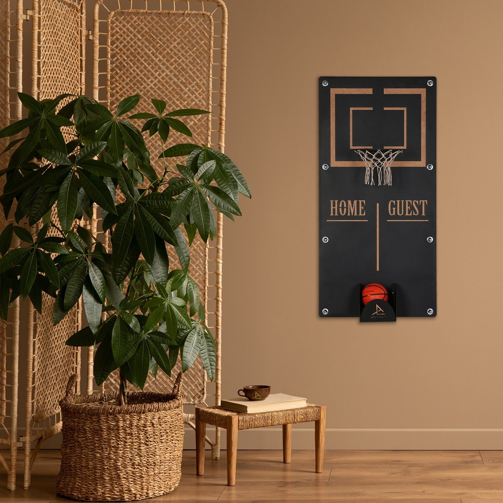 Black wall-mounted basketball wall game with gold trim home guest text and orange ball in the ball holder target area