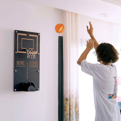 Black wall-mounted basketball wall game with gold trim home guest target area and small net ball holder for indoor play