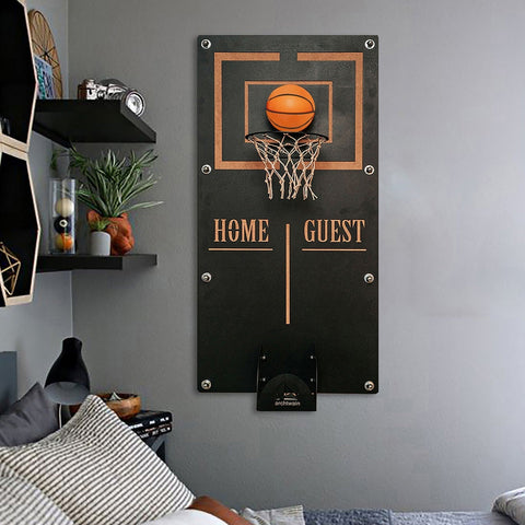 Black wall-mounted basketball wall game with orange rim net ball holder and gold home guest text target area