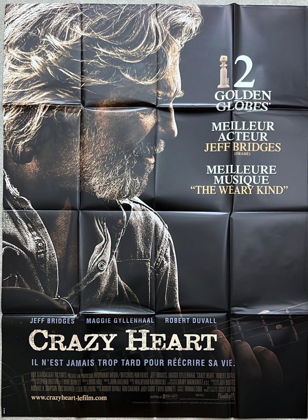 Black movie poster for crazy heart 2009 featuring close-up of jeff bridges with acoustic guitar on neck
