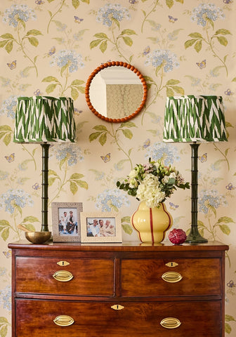 Yellow ceramic vase with red stripes next to cream and beige patterned photo frame 6x4 with floral design