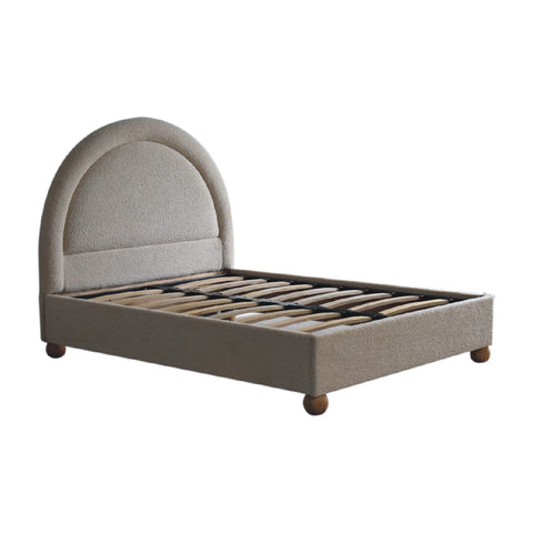 Cream boucle double bed with beige upholstered curved headboard and wooden ball feet
