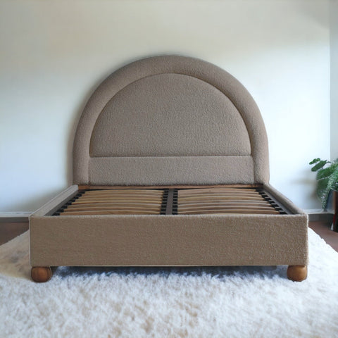 Cream boucle double bed with beige upholstery curved headboard and wooden legs perfect for cozy bedrooms