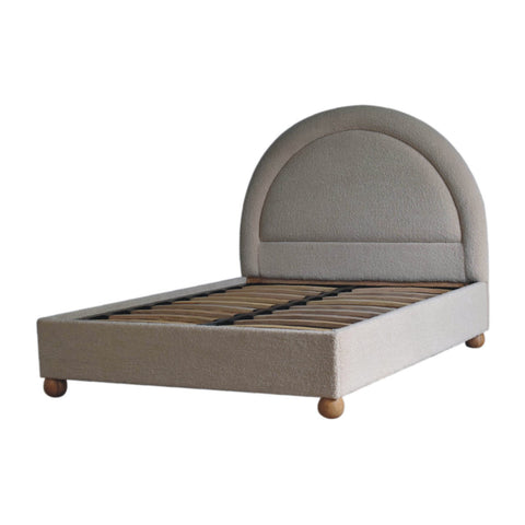 Cream boucle double bed with beige upholstery curved headboard and wooden ball feet perfect for cozy bedrooms