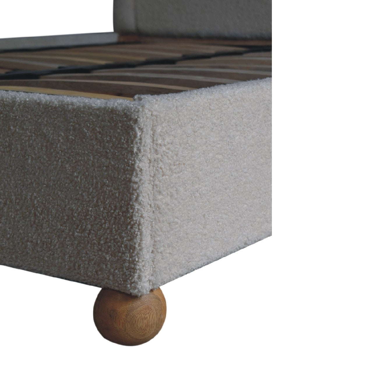 Cream boucle double bed with beige upholstered frame and wooden ball feet for stylish bedroom decor