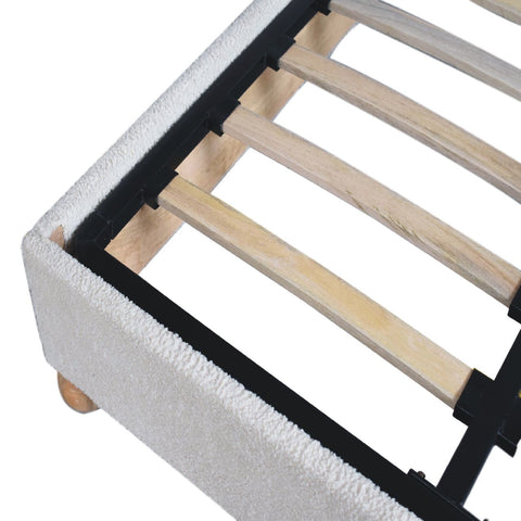 Cream boucle double bed with white textured fabric frame light wood slats and black metal supports