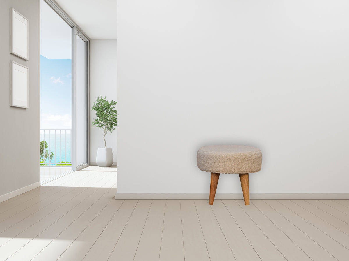 Cream boucle petite footstool in beige faux fur with tapered wooden legs perfect for cozy seating or footrest