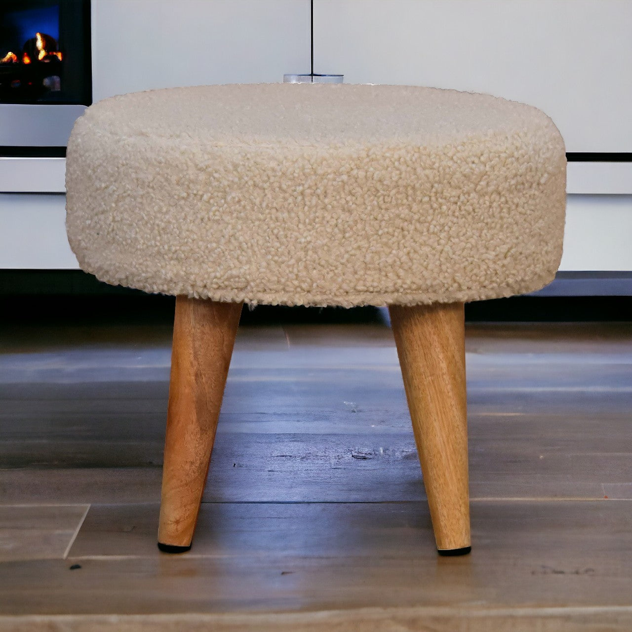 Cream boucle petite footstool with beige fuzzy upholstery and tapered wooden legs perfect for extra seating