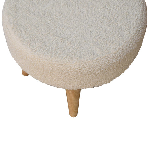 Cream boucle petite footstool with cream sheepskin texture and light wood legs perfect for cozy seating