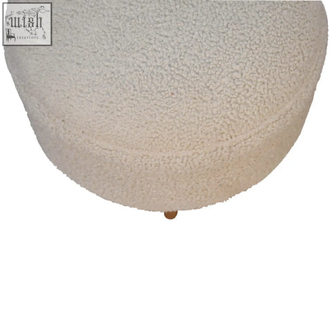 Cream boucle rounded footstool with cream-colored plush upholstery and a single solid mango wood leg at the base