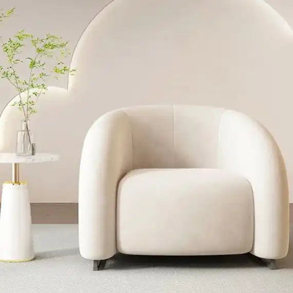 Cream-colored armchair with curved backrest and modern design, likely from a contemporary furniture brand.