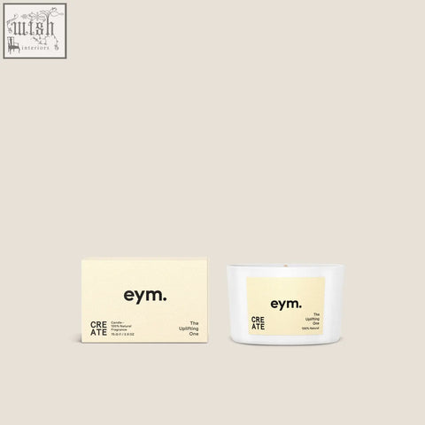 White ceramic mini candle with pale yellow label and black text shown with matching minimalist box