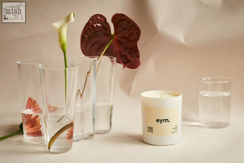 White cylindrical standard candle with beige label featuring eym brand name and the word create in black text