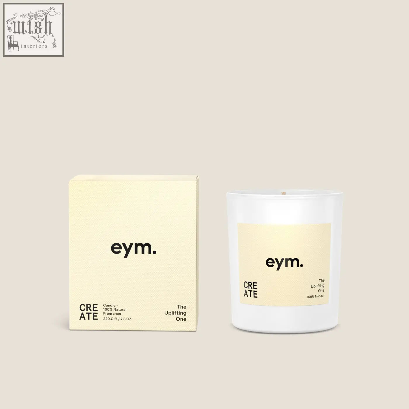 White glass standard candle with pale yellow eym label the uplifting one and matching cream-colored box