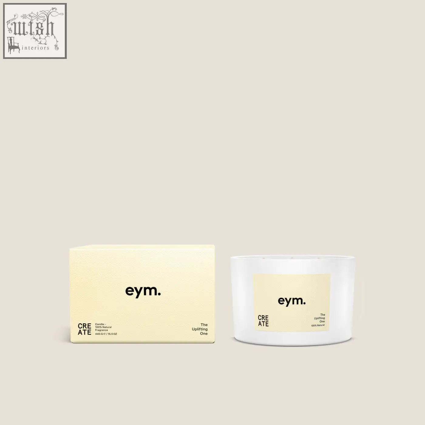 White cylindrical three wick candle with pale yellow label reading eym the uplifting one in minimalist black font