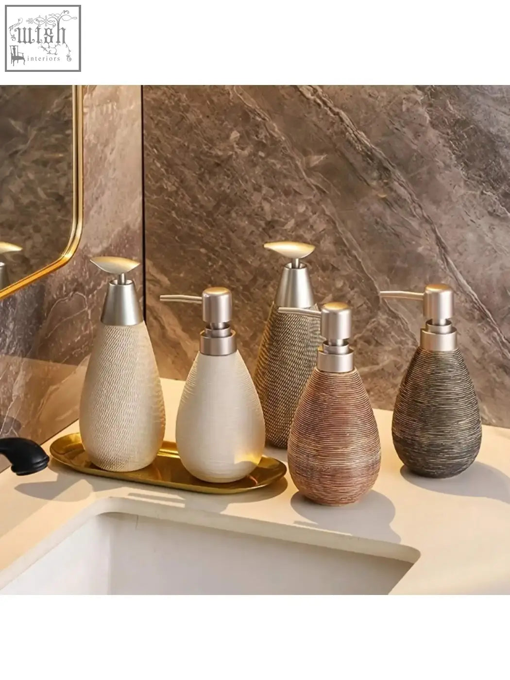Set of four retro style textured glass soap dispensers with metallic pumps in neutral tones for hand soap use