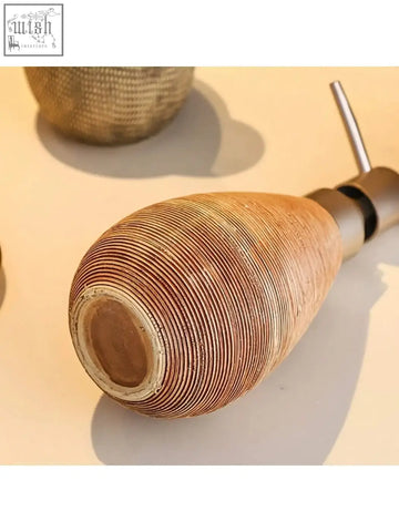Terracotta ceramic soap dispenser with ribbed texture and metallic pump perfect for retro style hand soap use