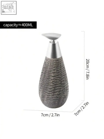Silver-toned retro style ceramic soap dispenser with textured teardrop shape and sleek metallic pump for hand soap use