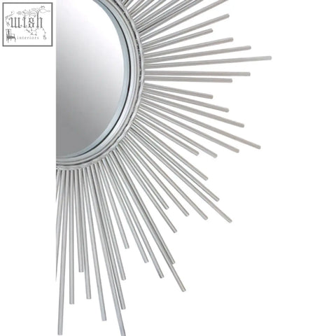 Silver sunburst wall mirror with cristal silver finish and radiating metal rays for stylish decor